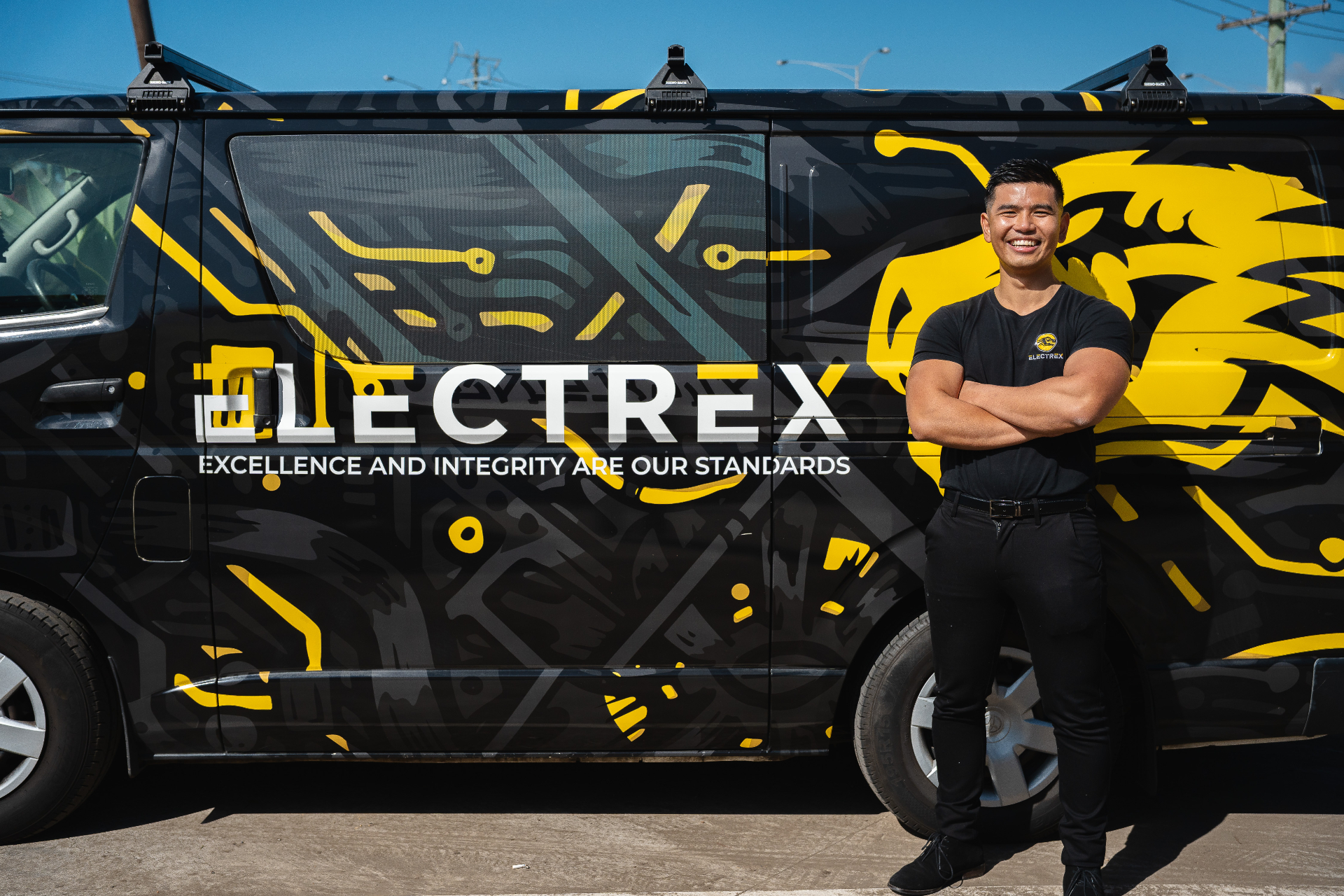 Electrex technician standing in front of branded service van