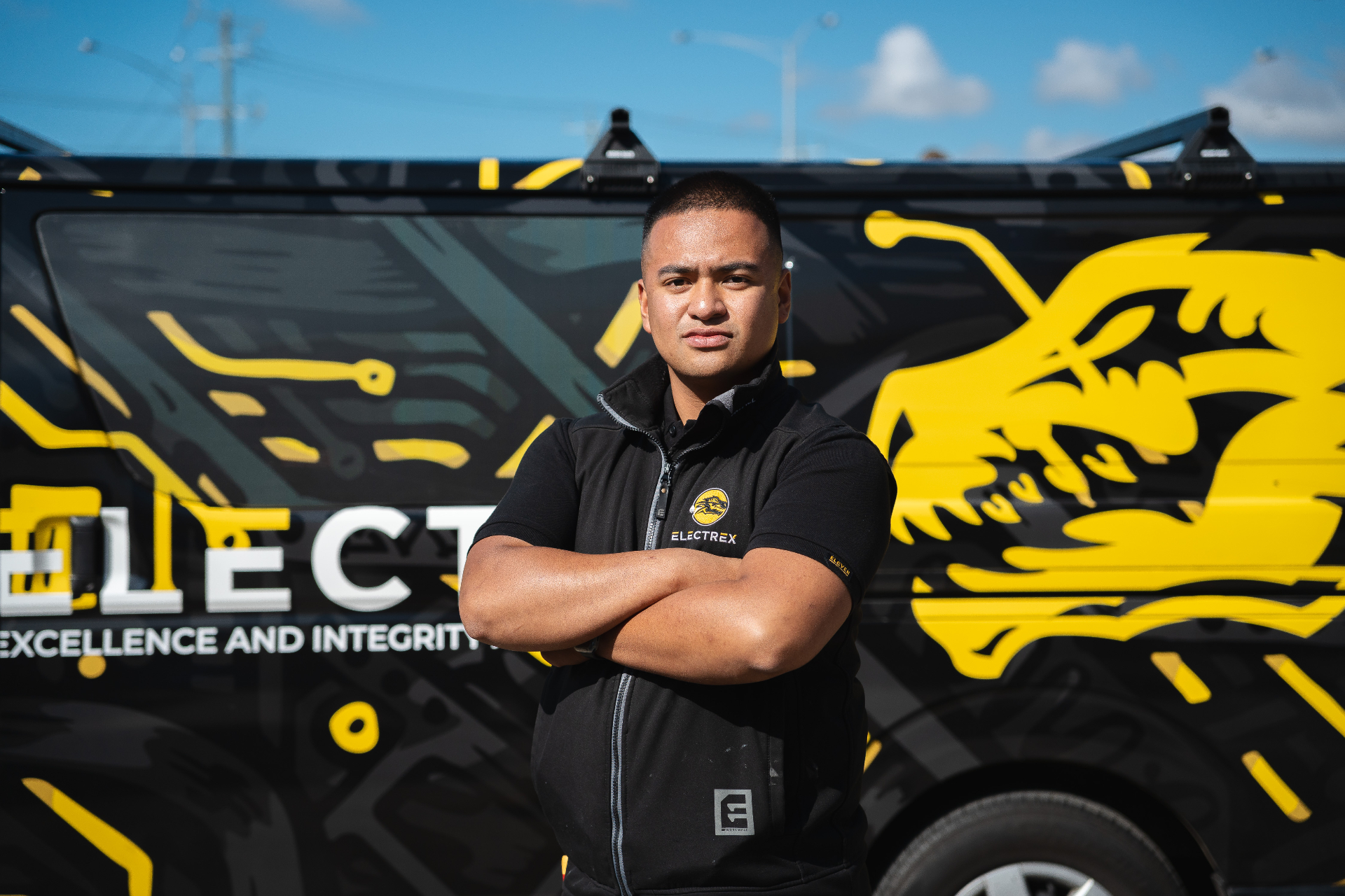 Electrex technician standing in front of branded service van