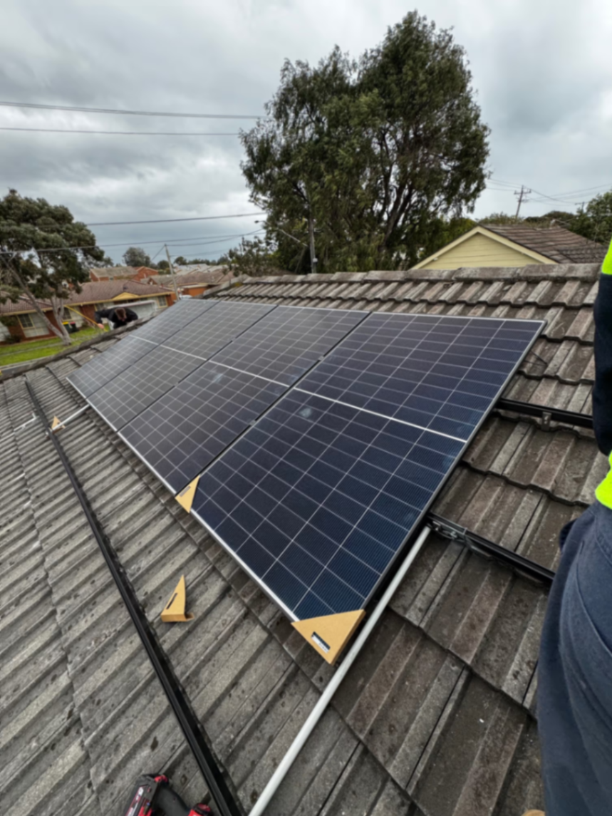 Solar panel installation in progress on tiled roof